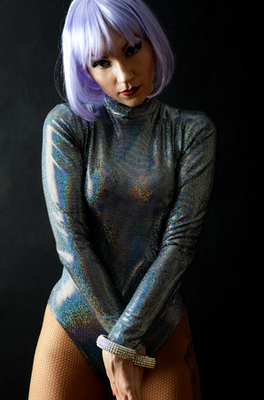 Young girl, dancer wearing costume. Female model with special metallic costume and light purple wig.の写真素材