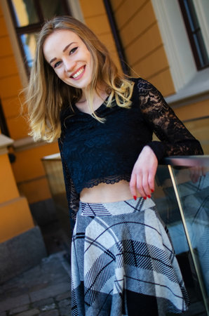 Blonde female model in her 20's at Wroclaw's railway station. Smiling young woman with short skirt.の写真素材