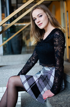 Blonde female model in her 20's at Wroclaw's railway station. Young woman with short skirt.の写真素材