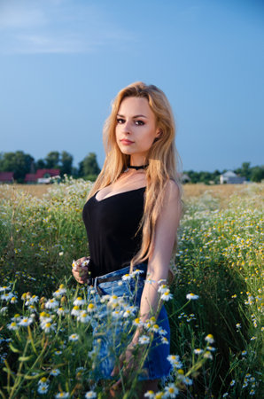 Beautiful, young woman posing for outdoor photos. Summer in Poland, woman surrounded by flowers.の写真素材
