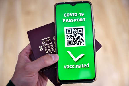 Traveling during SARS-CoV-19 pandemic. Covid-19 passport application in mobile phone.の写真素材