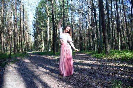 Pretty, young woman posing in the forest. Green surroundings during spring in Poland.の写真素材