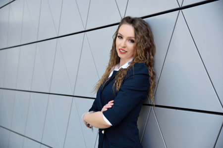 Businesswoman in Poland. Portrait of young office lady with modern building as background.の写真素材
