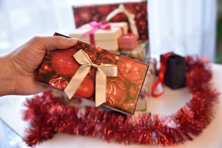 Christmas season approching. Colorful gift boxes, packed presents with Christmas style packing paper and ribbons.の写真素材