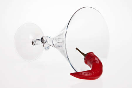 A red chilli pepper and wine glass.の写真素材