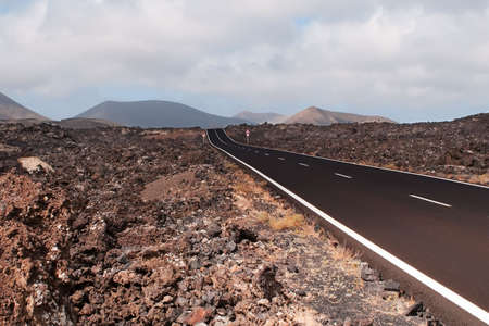 Road in volcanic scenery at Lanzarote, Canary Island.の写真素材