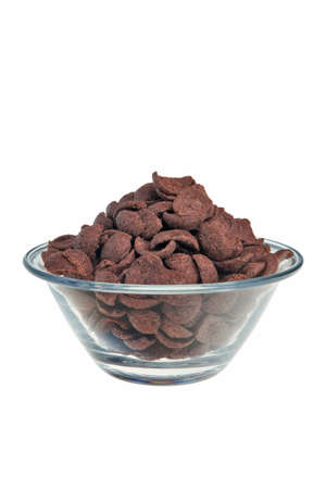Chocolate flakes in transparent bowl over white background.の写真素材