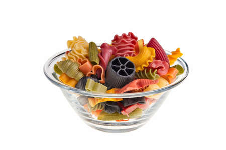 Italian colourful pasta isolated over white background in transparent bowl.の写真素材