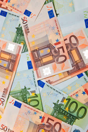 100 and 50 Euro banknotes in random pattern on each other.の写真素材