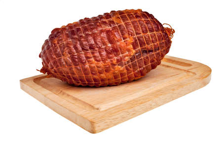 Big tasty smoked ham on board isolated over white background.の写真素材