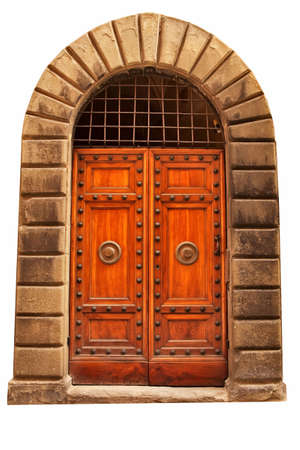 Wooden closed brown door with ornaments and two doorknobs, Italy.の写真素材