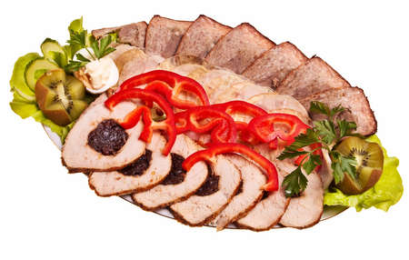 Dish with sliced meat stuffed with plums, pate, ham and red pepper.の写真素材