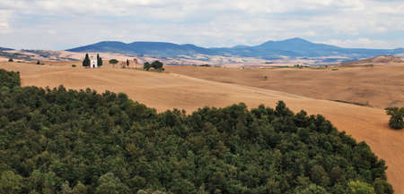 Small chapel on a hill in Tuscan farmland.の写真素材