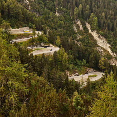 Serpentine road in mountains with forest on both sides.の写真素材