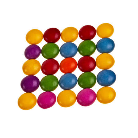 Button shaped colorful candies over white background in square pattern.の写真素材