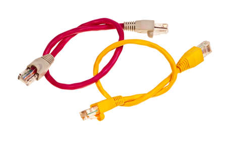 Yellow and pink wisted pair patchcords isolated over white background.の写真素材