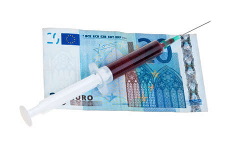 Syringe with red liquid on 20 Euro banknote isolated over white background.の写真素材