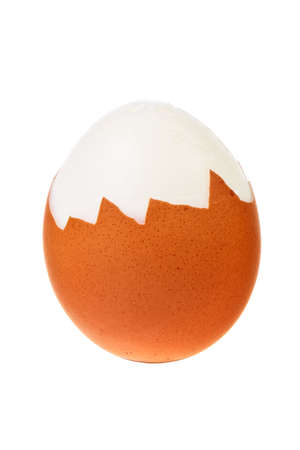 Hard boiled egg with its shell partially removed isolated over white background.