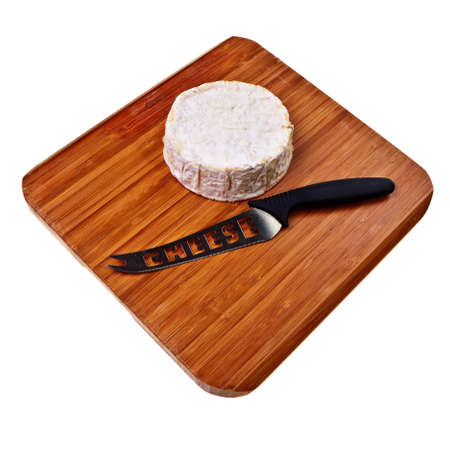 Round camembert block on wooden board with cheese knife.の写真素材