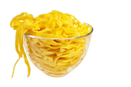 Cooked italian pasta in glass transparent bowl isolated over white background.の写真素材