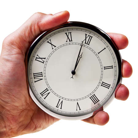 Minute to midnight or noon on retro watch hold in male hand isolated over white background.の写真素材