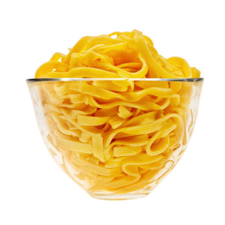 Cooked italian pasta in glass transparent bowl isolated over white background.の写真素材