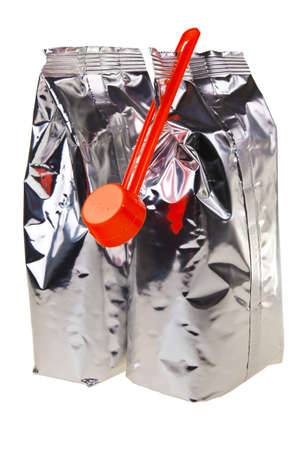 Aluminum baby food bags with plastic spoon isolated over white background.の写真素材