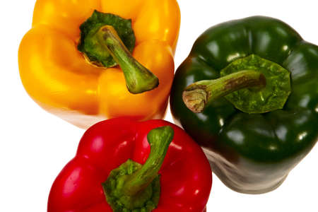 Three peppers red, green and yellow top view, isolated over white background.の写真素材