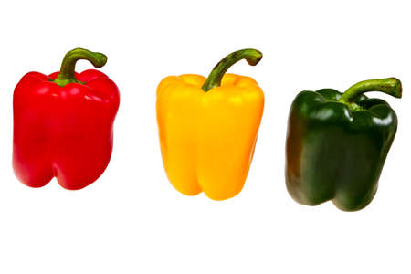 Three peppers red, green and yellow isolated over white background.の写真素材