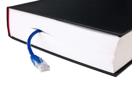 Book in hardcover with blue LAN patch cord isolated over white background.の写真素材