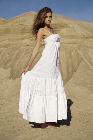 Fashionable young attractive and sensuality woman dancing in the desertの写真素材
