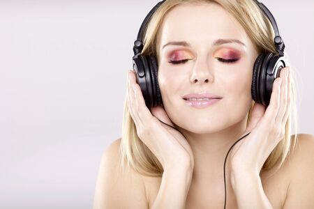Beautiful adult sensuality blonde girl is listen to the musicの写真素材