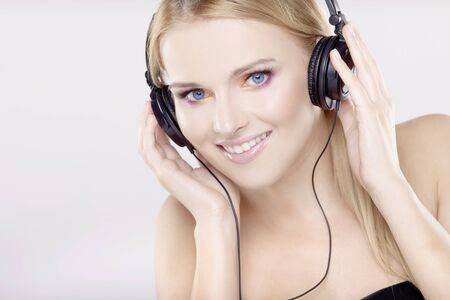 Beautiful adult sensuality blonde girl is listen to the musicの写真素材