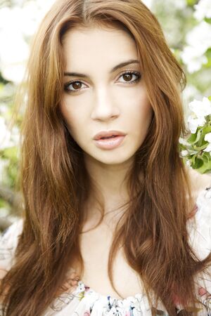 portrait beautiful and attracitive brunette in the gardenの写真素材