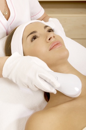 Laser hair removal in professional studio. Beautiful brunette woman.の写真素材