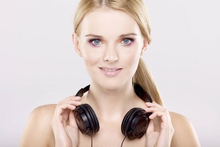 Beautiful adult sensuality blonde girl is listen to the musicの写真素材
