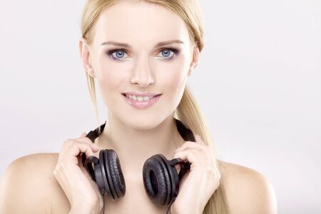 Beautiful adult sensuality blonde girl is listen to the musicの写真素材