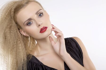 Young pretty woman with beautiful blond hairs and multicolor makeup isolated on white backgroundの写真素材