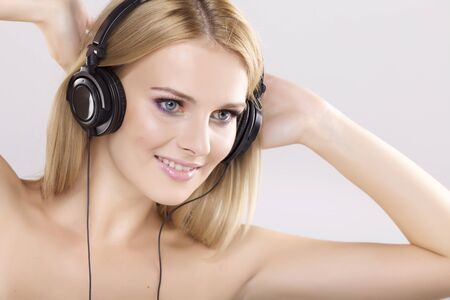 Beautiful adult sensuality blonde girl is listen to the musicの写真素材