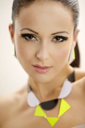 portrait of a beautiful adult sensuality brunette woman in multicolor makeup isolated on white background の写真素材