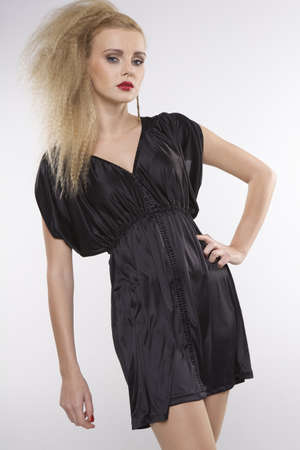 Young pretty woman with beautiful blond hairs and multicolor makeup isolated on white backgroundの写真素材
