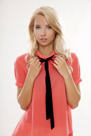 Young pretty woman with beautiful blond hairs in red blouse shirt isolated on white backgroundの写真素材