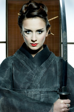 beautiful japanese grey kimono woman with samurai sword in traditional roomの写真素材