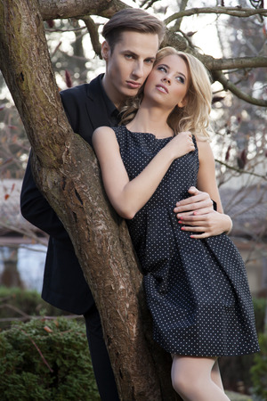 Portrait of young adult couple in love posing in classic elegance clothes to dateの写真素材