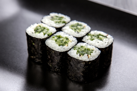 Sushi Maki roll assortment on black dishの写真素材