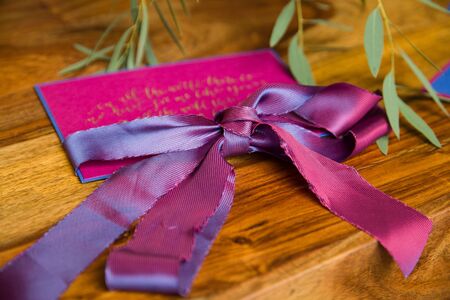 Handmade wedding invitations with fuchsia ribbonの写真素材