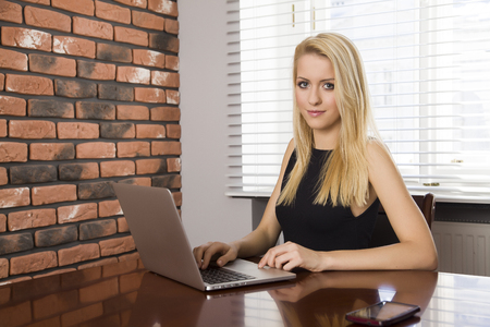 Portrait of a beauty young adult attractive business woman using laptop at officeの写真素材