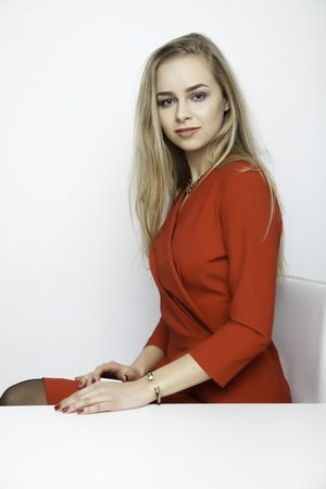Young pretty woman with beautiful blond hairs and multicolor makeup isolated on white backgroundの写真素材