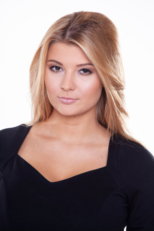 Close up portrait of a young adult attracive pretty blonde woman in black dress isolated on white backgroundの写真素材