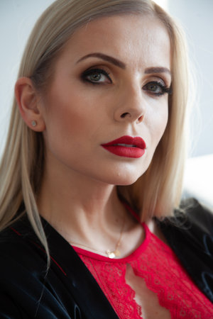 close up portrait of attractive young blonde adult woman with beautiful perfect red lipsの写真素材